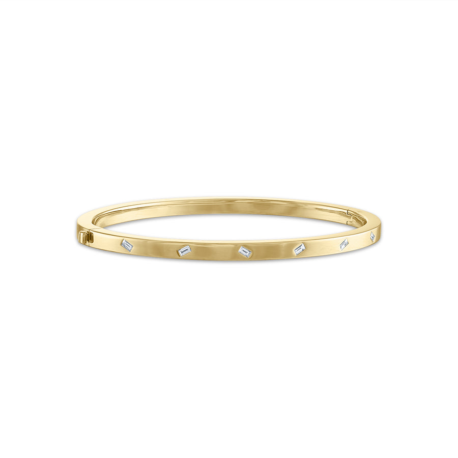 14K yellow gold bangle bracelet with baguette diamonds.