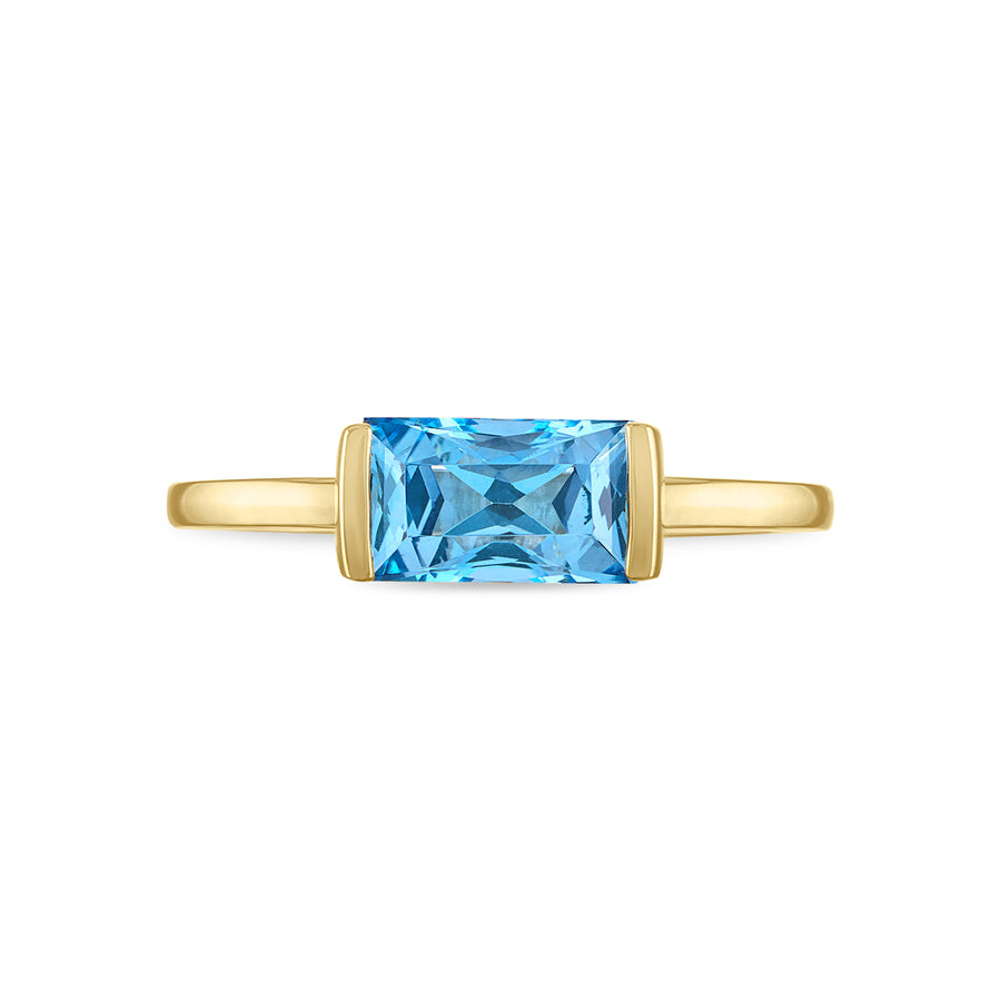Top view of a 14K gold blue topaz ring in an easy-west setting.
